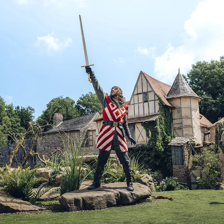 Tristan retirant l'épée excalibur du rocher dans le spectacle L'Epée du Roi Arthur